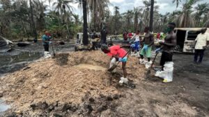 A person digs a grave for the mass burial of victims of the explosion at the illegal bunkering site in Imo state, April 26, 2022. (Photo: Reuters/Tife Owolabi)