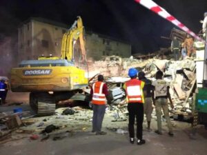 Rescue workers searching for survivors at the site of the building collapse