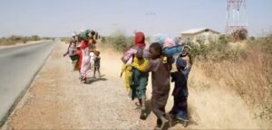 A screen grab from the BBC programme shows a group of women and children fleeing their village after a deadly attack by the bandits (Photo: BBC / New Citizen)